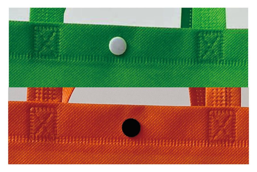 A central snap-button or riveted fastener on the reinforced top hem band. Reinforced box-X stitch sewing pattern at the base of the handle for extra strength and load-bearing durability.
