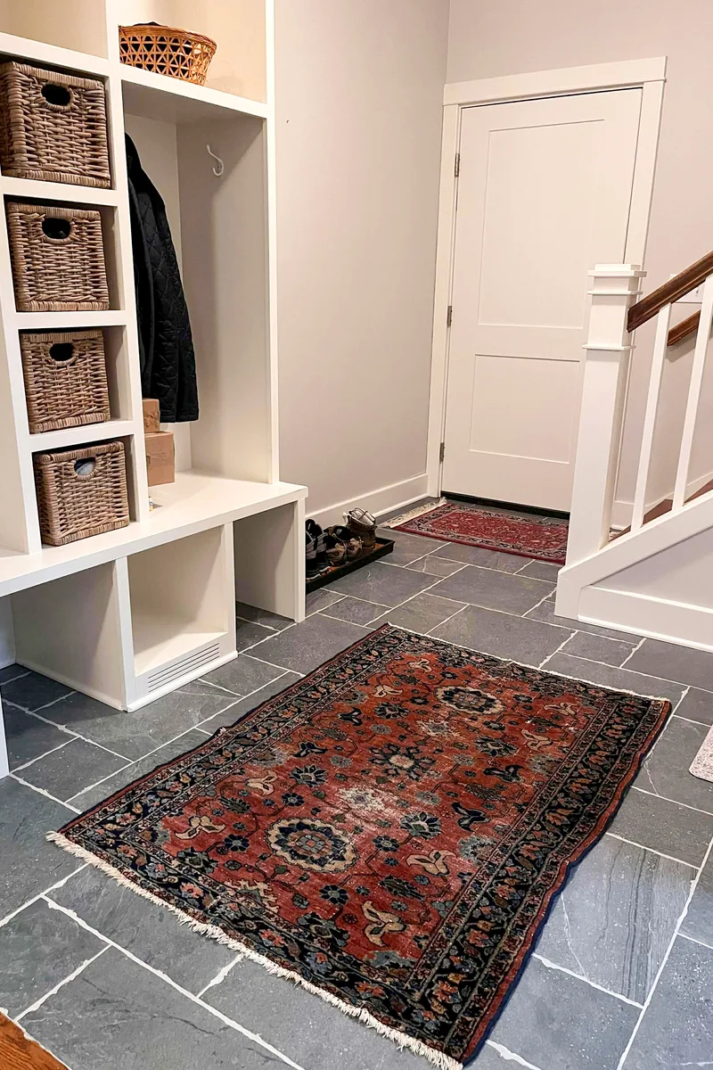 Rug on slate floor.