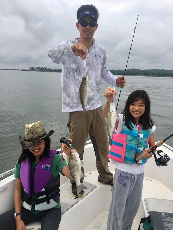 Three casts, and three fish. That's how White Bass fishing can be when you find a feeding school.  Here the author and his daughters show some average-sized White Bass