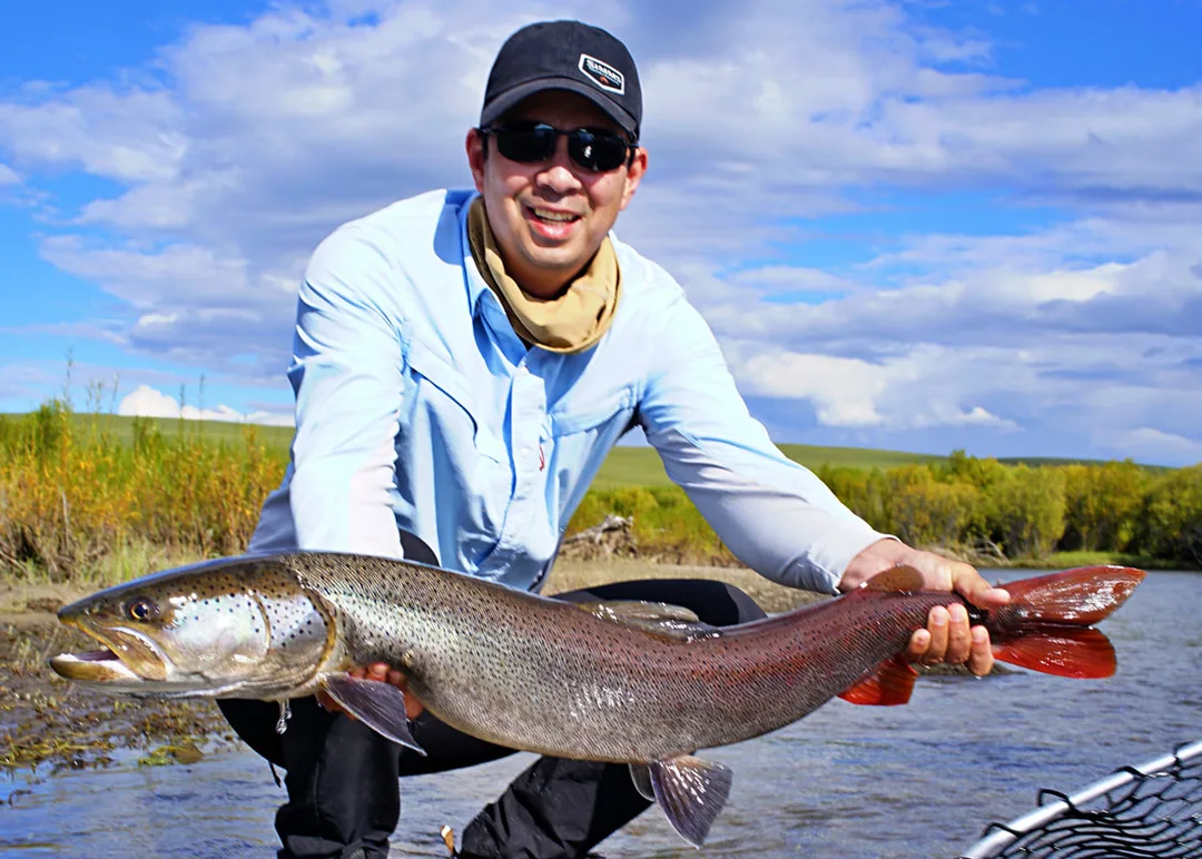 A Taimen caught on a streamer fly on the Onon River, Mongolia