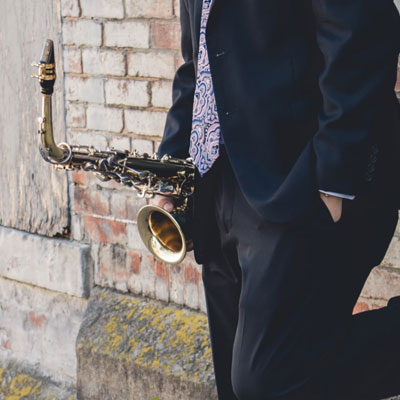 Photo of man holding a saxophone