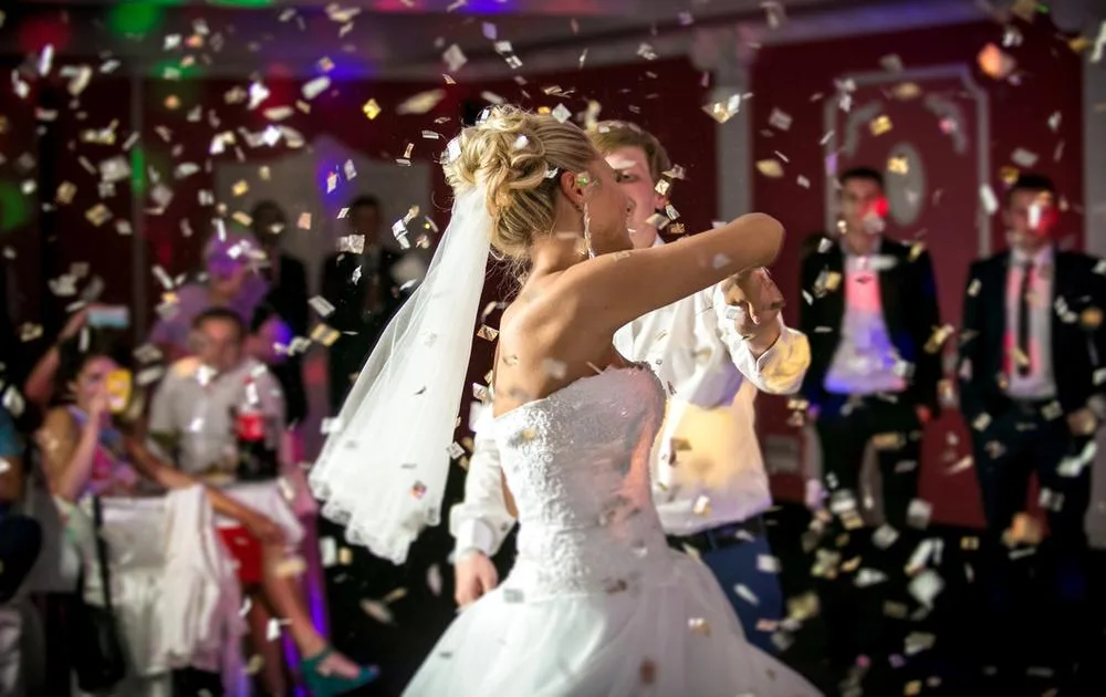 Newlyweds dancing to music with confetti falling_How to plan music for your wedding_blog image for Saxophonist for Hire in Essex, London, Kent, Surrey and Sussex.