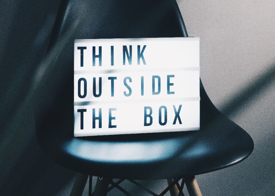 a black chair with neon lights on the seat that reads, think outside the box_plastering and rendering services_gk rend