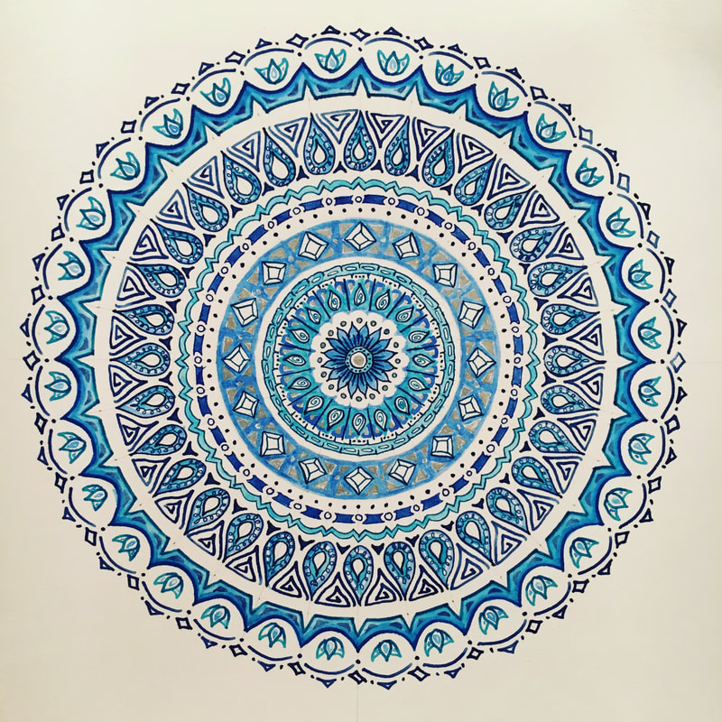 hand drawn pen and ink mandala with lotus flowers