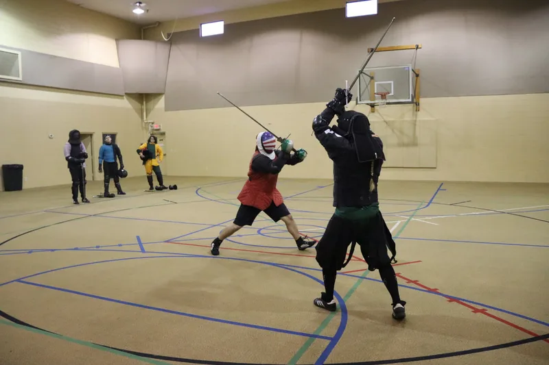 Instructor Jason and Free Scholar Neal mid-longsword fight.