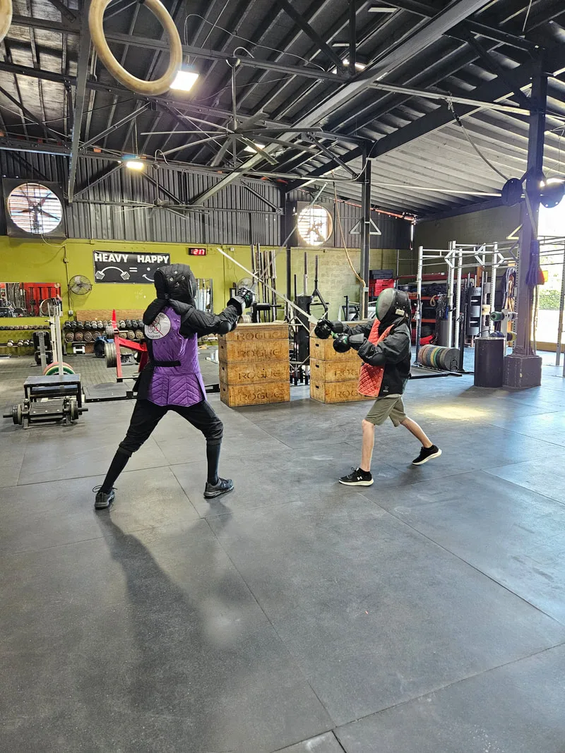 Instructor Braam and teen student doing a longsword drill.