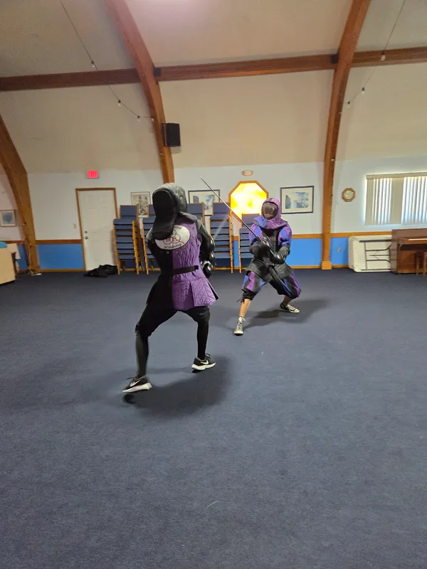 Instructor Braam during a longsword fight with teen student Dominic.
