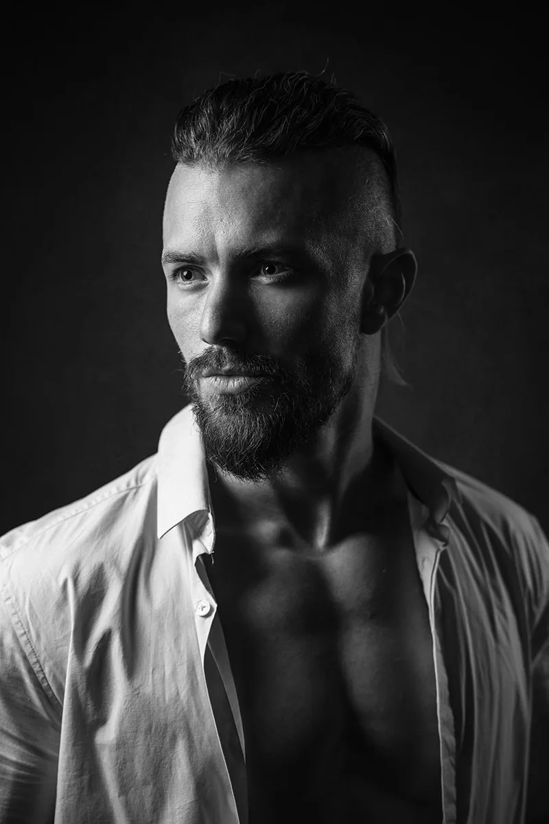 Photo de book de mode masculine en studio du modèle John Liess en chemise blanche