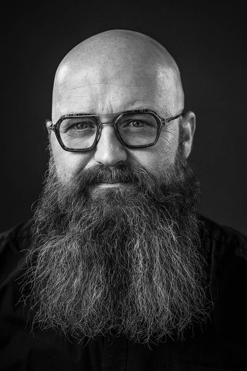 Portrait masculin en noir et blanc d'un homme barbu portant des lunettes, réalisé à Metz