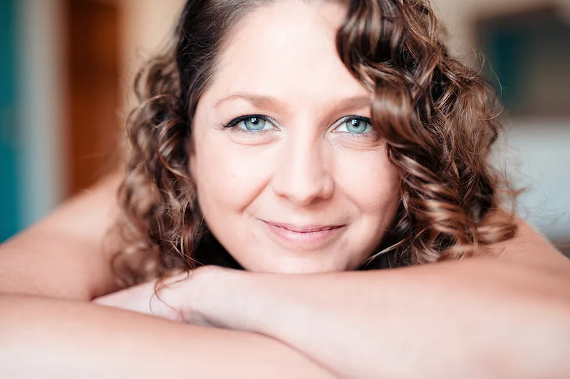 Portrait lumineux d'une femme souriante aux yeux bleus respirant le bonheur