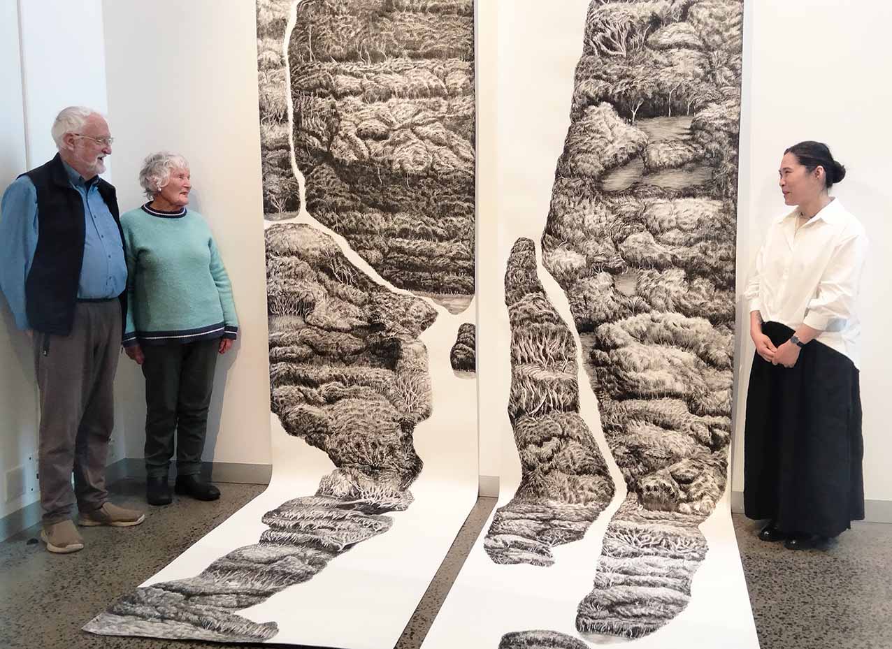 Phillip Island Conservation Society president Greg Johnson and former president Anne Davie with artist Hoa Nguyen, Berninneit, 2026