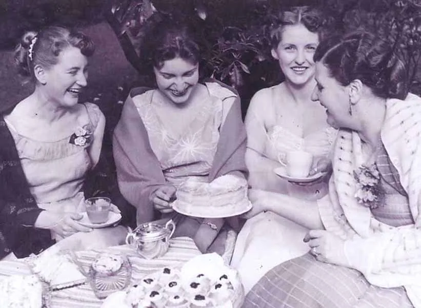 Goldie Guthrie serving sponge cake to three young women at the hospital garden party, 1955. Photo: W&DHS