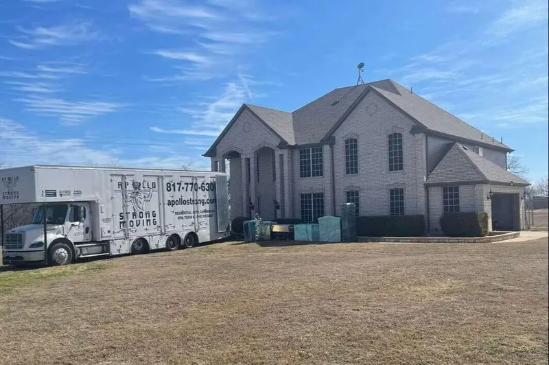 Large 40FT Box Truck showing Local Arlington TX Movers Apollo Strong Moving parked in front of a Large Texas Home they were moving.