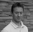 Julian Newhill Osteopath in white polo shirt head shot