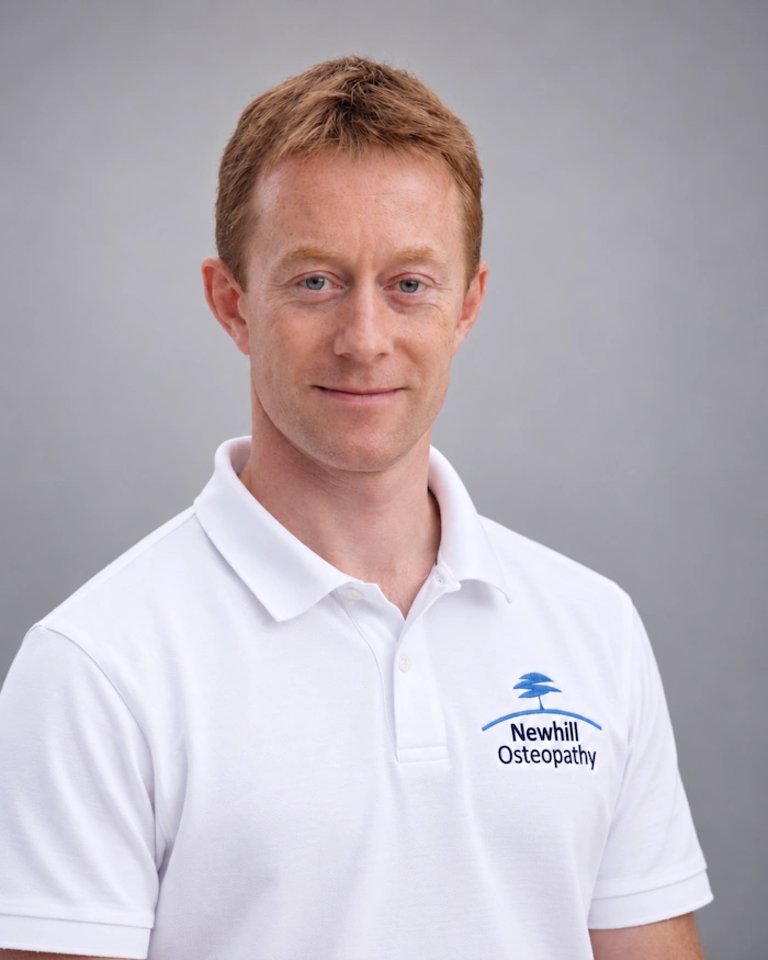 Julian Newhill Osteopath in white polo shirt head shot