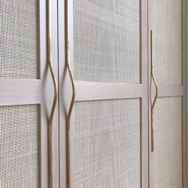 White wardrobe doors with cane insets and gold pulls