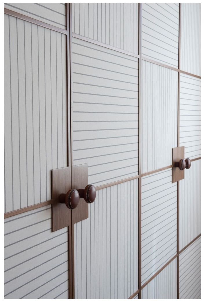 Fluted wood closet doors with round knob pulls