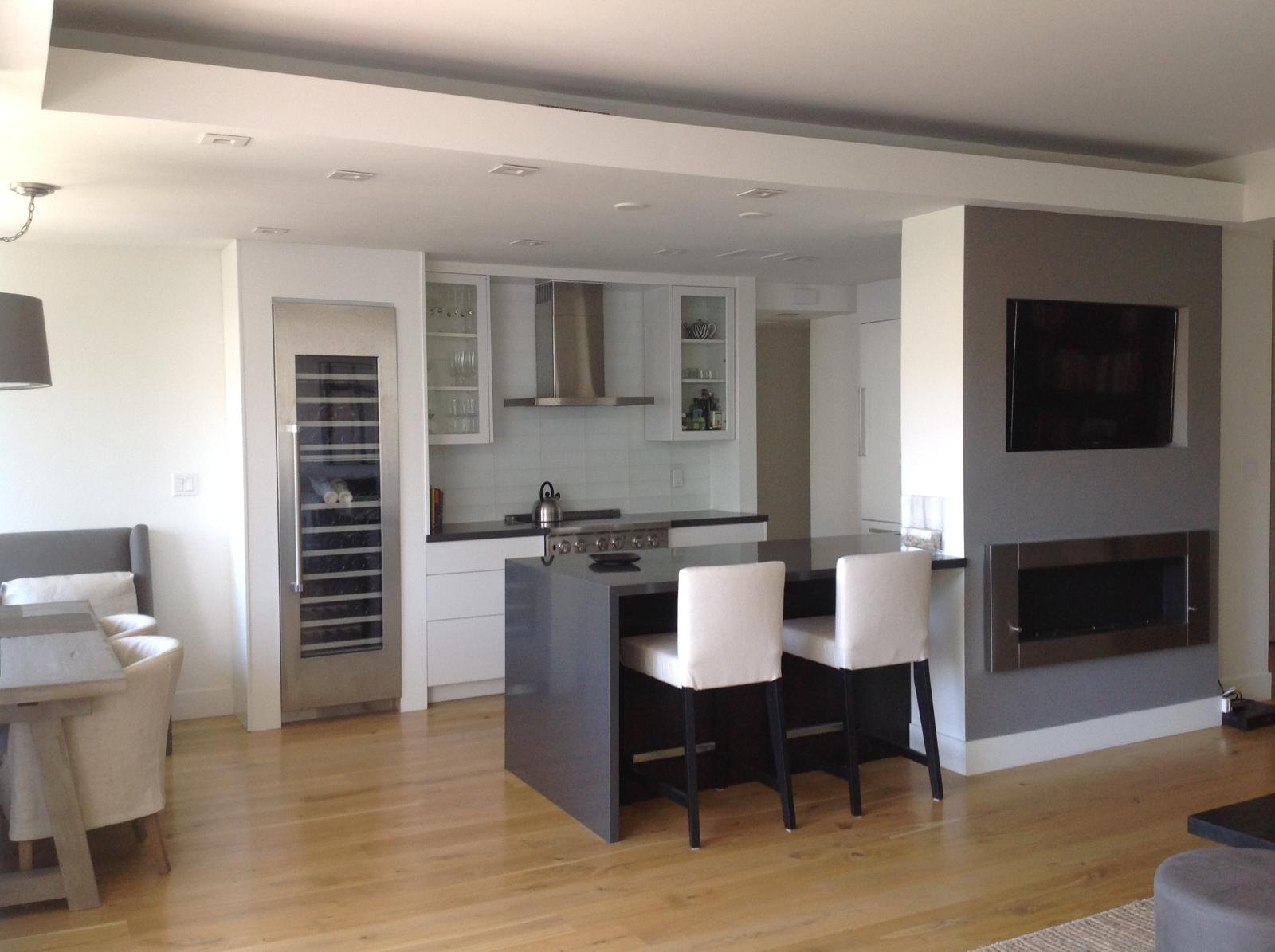 Open kitchen and living room with bar stools by Jill Seidner Interior Design
