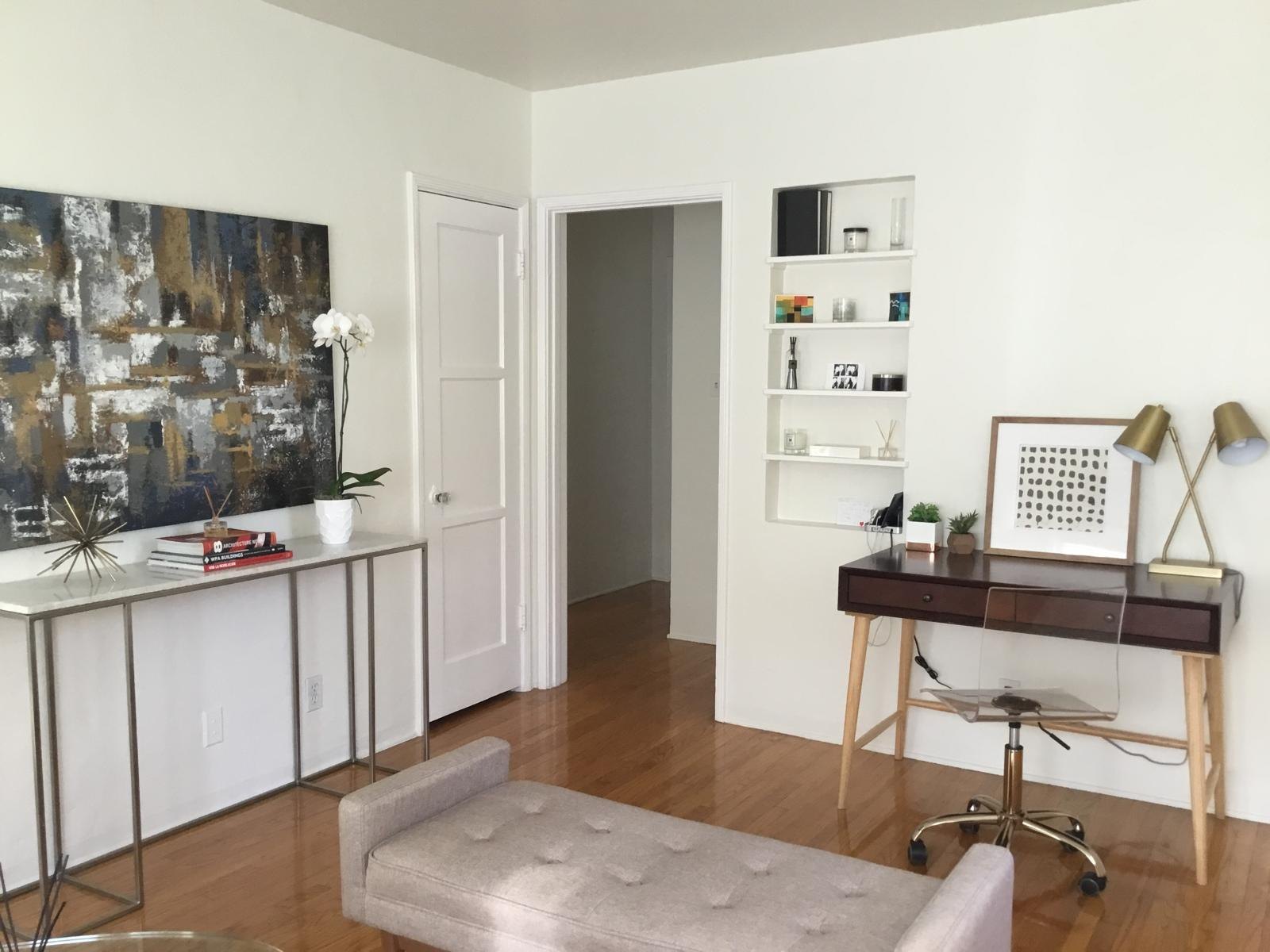Living room with a console, art and desk by Jill Seidner Interior Design