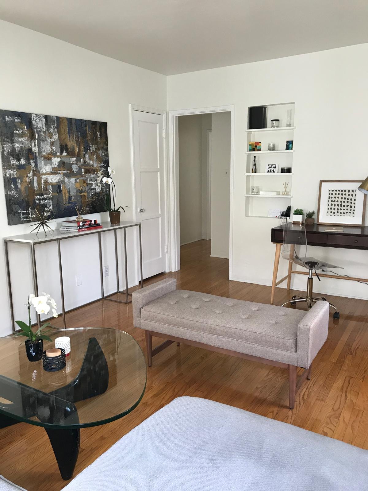 Living room with a bench and abstract art by Jill Seidner Interior Design