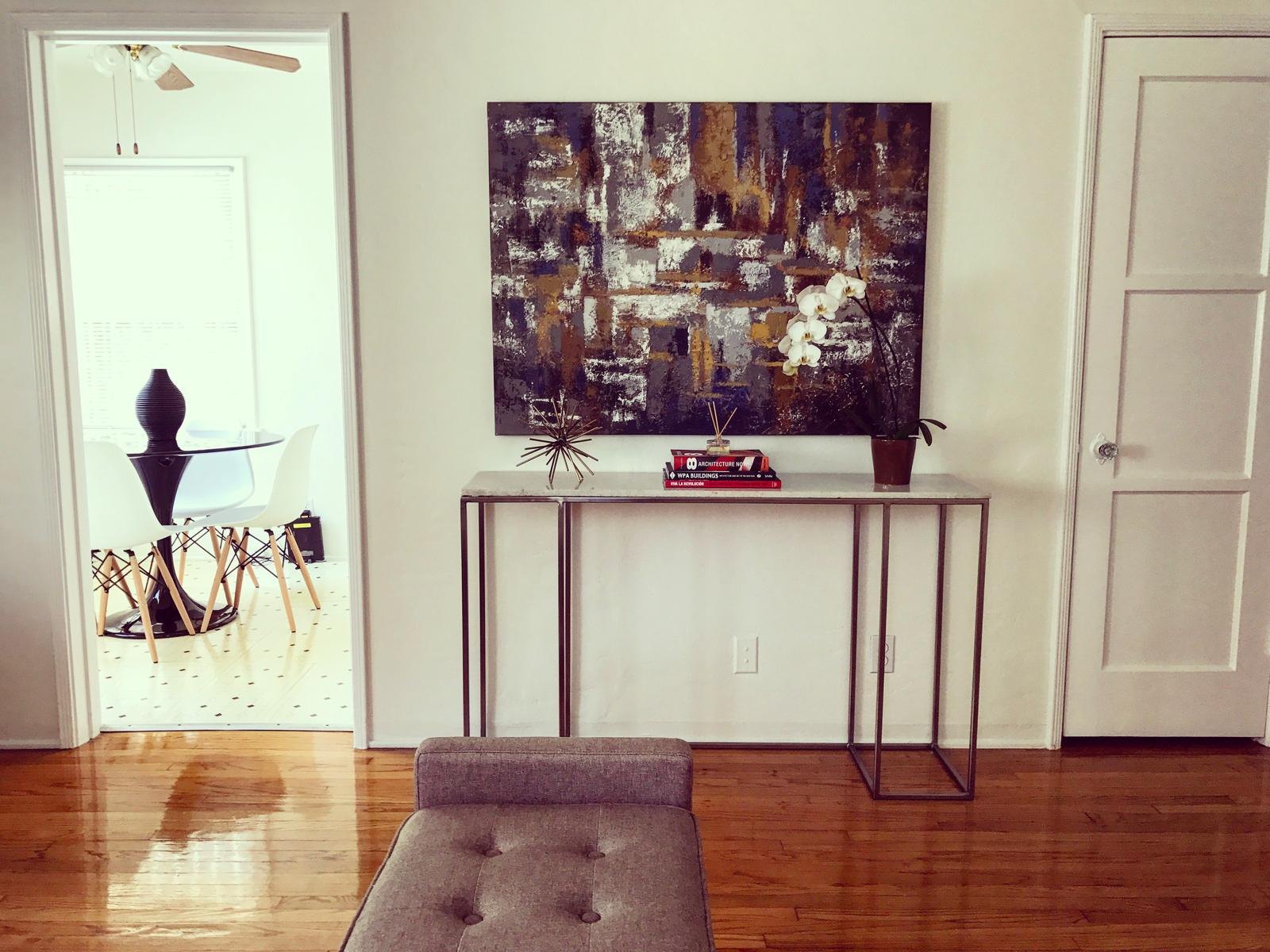 Entry with a console and abstract art by Jill Seidner Interior Design