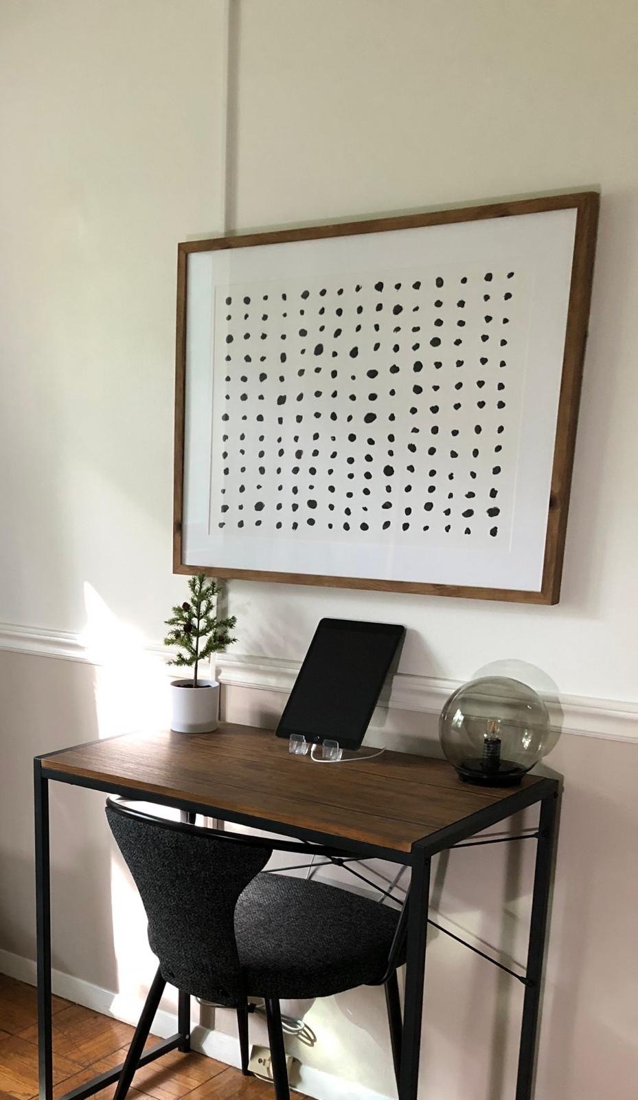 Home office nook with a desk and framed art by Jill Seidner Interior Design