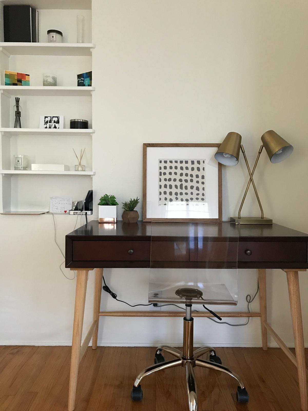 Home office with built-in shelves and a desk by Jill Seidner Interior Design