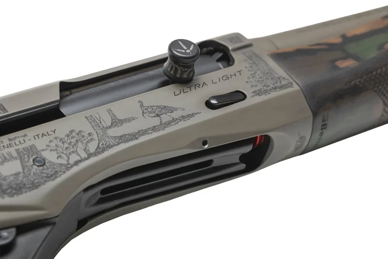 Detail of a laser-engraved wild turkey on a Custom Grey Cerakote Benelli Ultra Light 20 gauge receiver