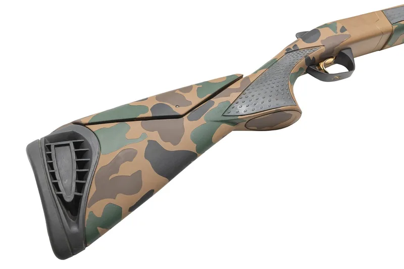 Angled view of a Browning Cynergy 12 gauge stock and pistol grip in a Troy Coyote Tan, Chocolate Brown, Graphite Black and Highland Green Cerakote camo pattern