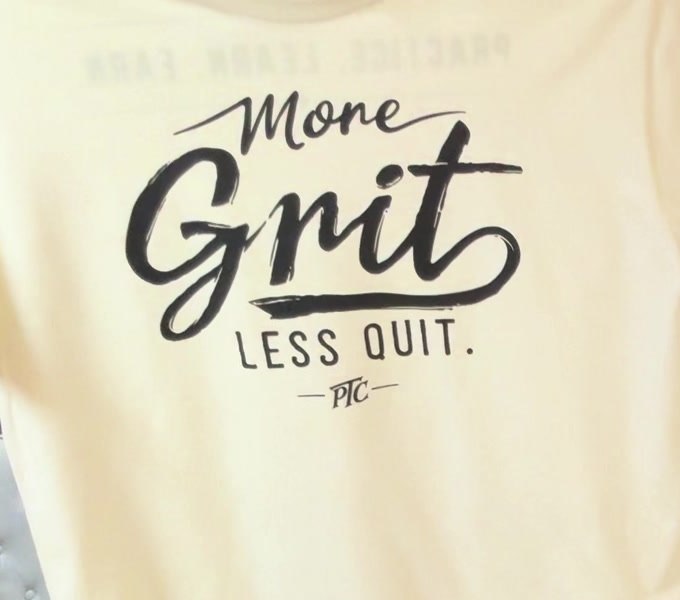 A close view of the cream shirt’s finished print as it is held up.