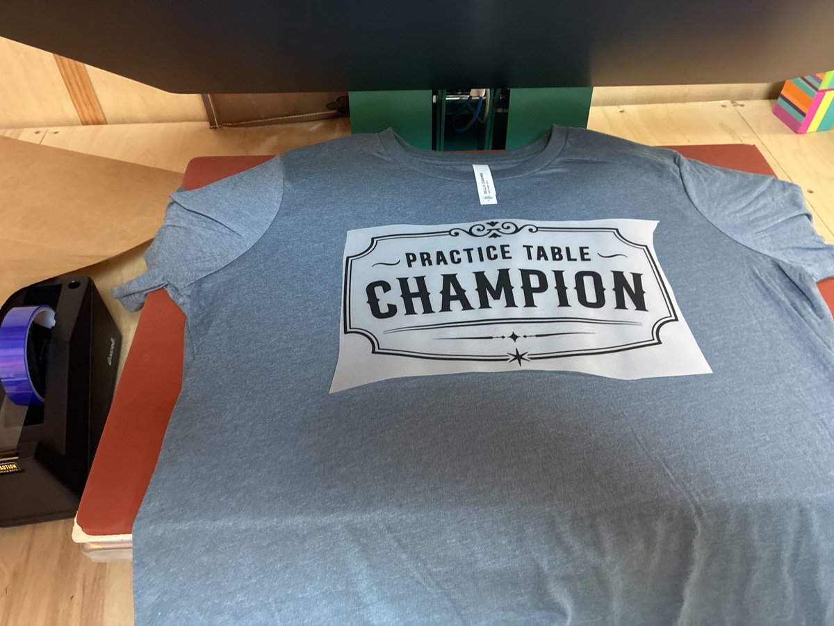 The Champion transfer positioned on a blue-gray shirt.