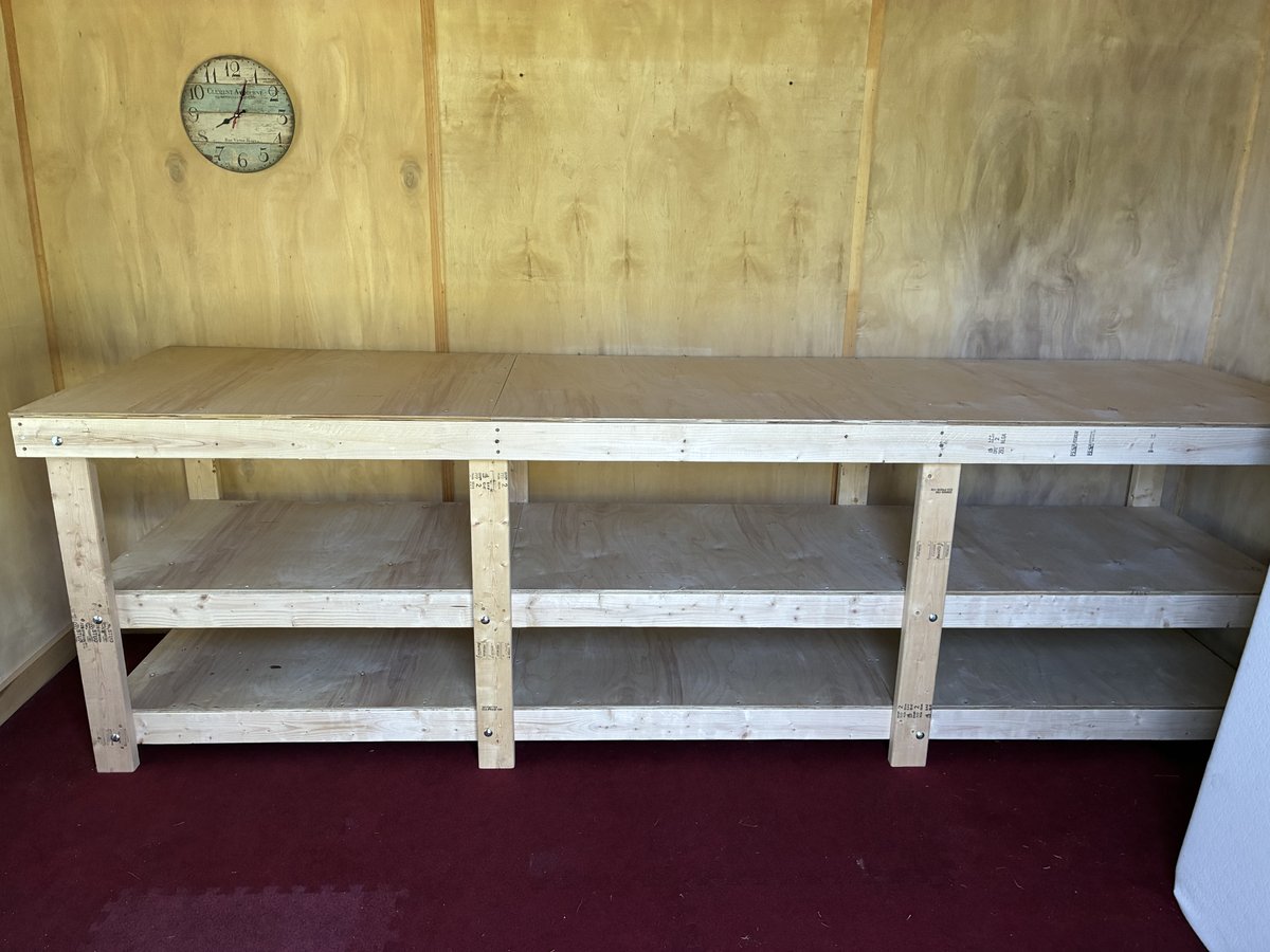 The long wooden bench installed against the workshop wall.