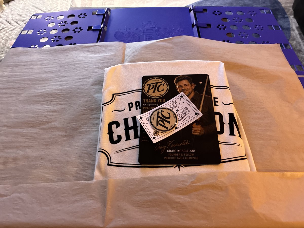 A folded shirt with tissue paper and printed PTC pieces.
