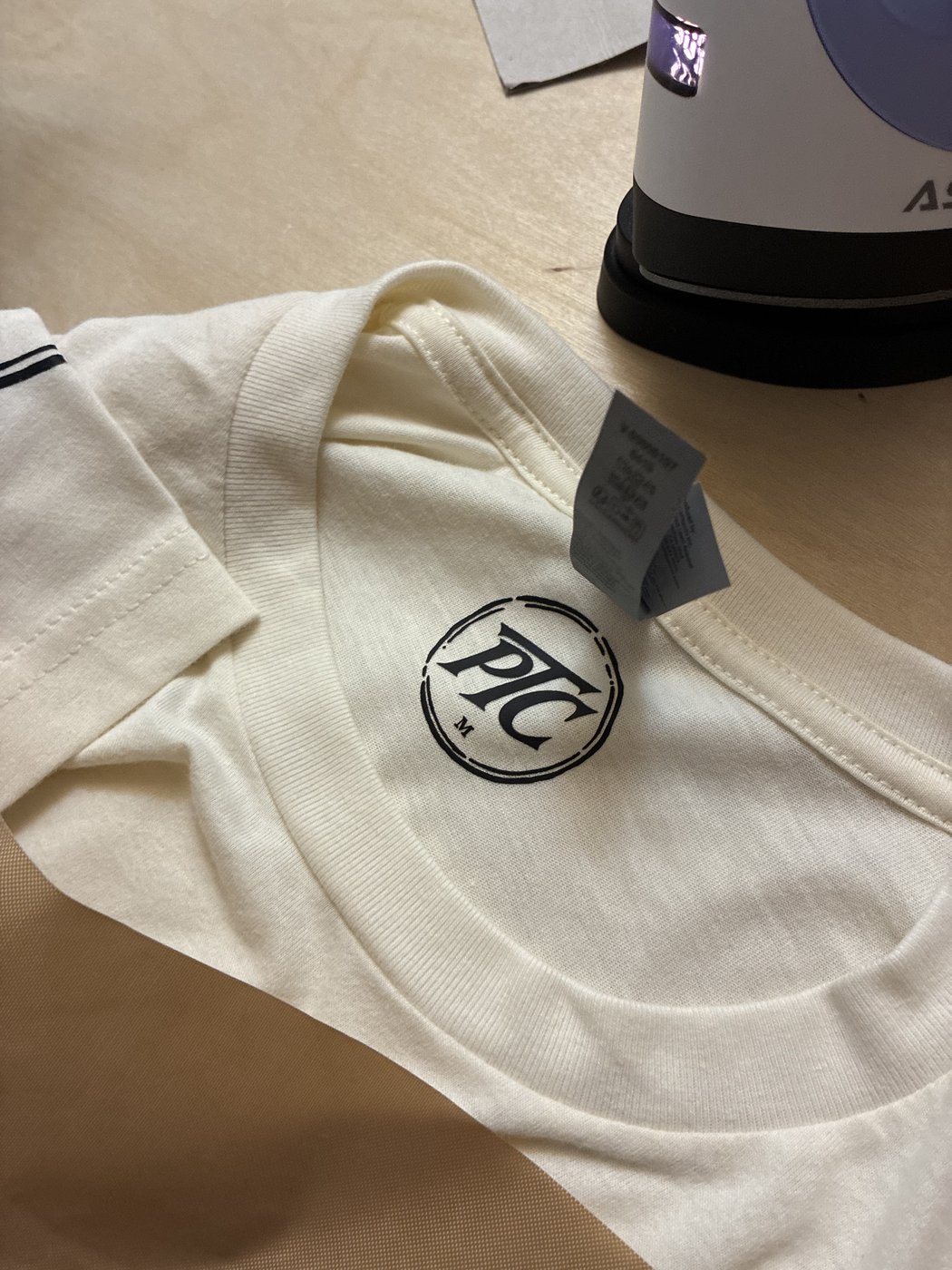 The PTC neck mark, with the small press beside the shirt.