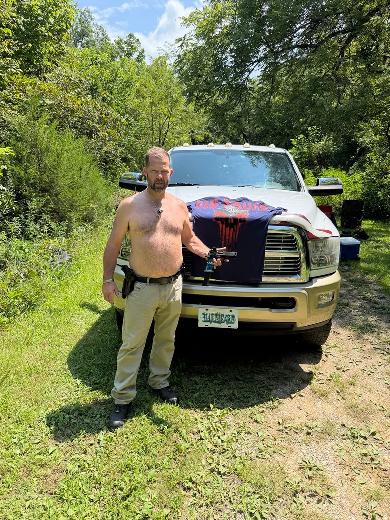 Andrew Gish beside the truck at the range