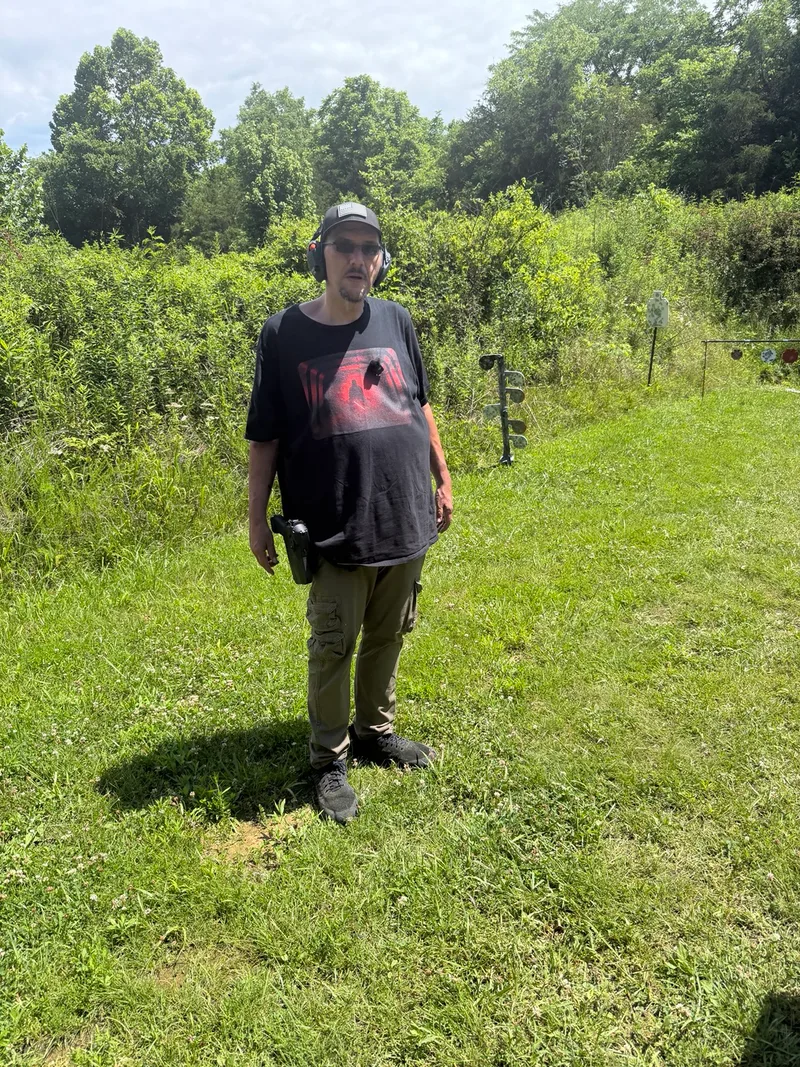James Warner at the range, wearing a black shirt and cap