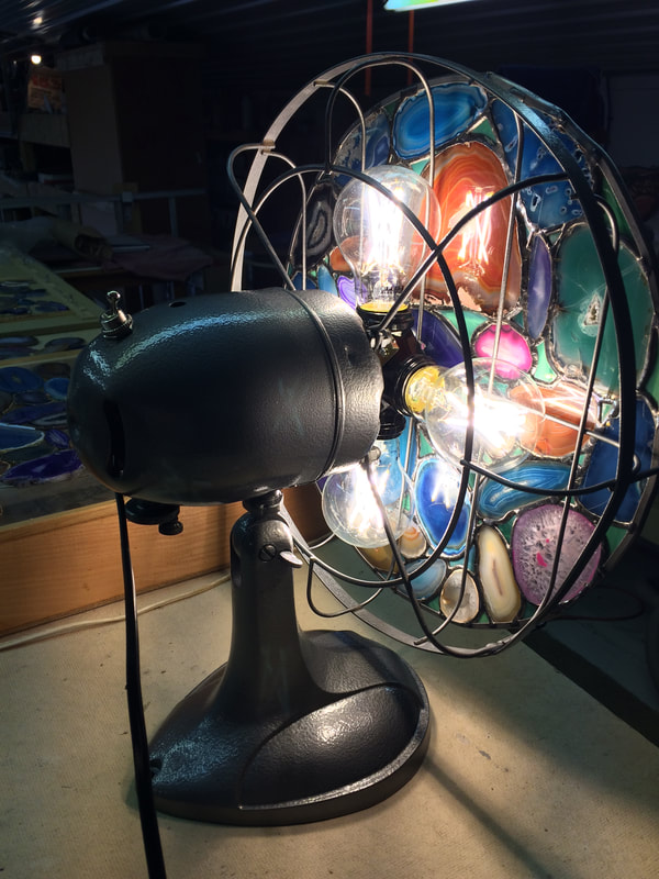 Agate rock slices in a removable disk in a fan lamp.