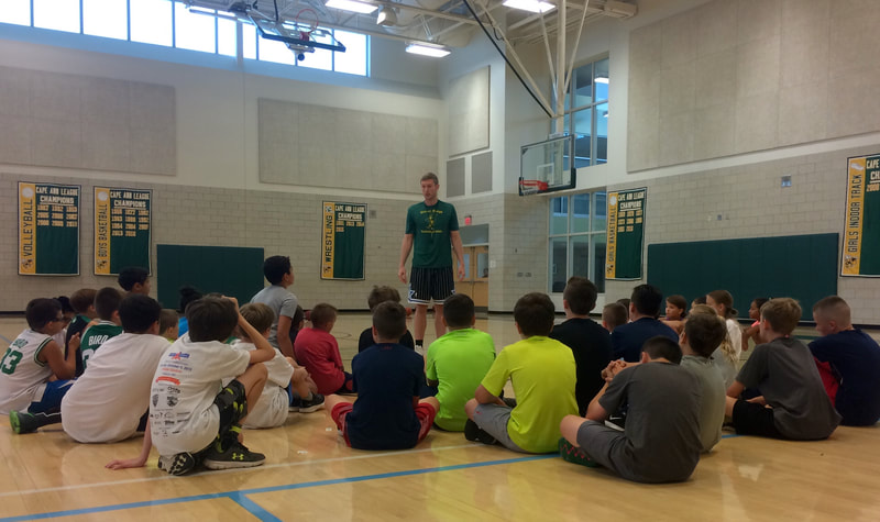 Coach Lentini talking to the campers.