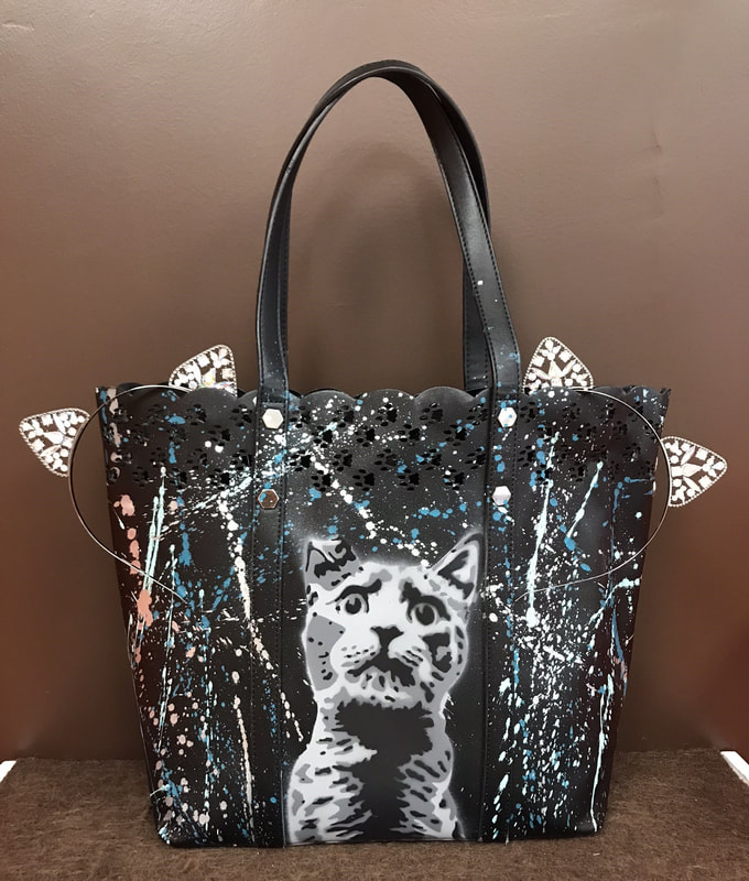 17. Black cat tote, cat scratcher, treats, toys, laser toy