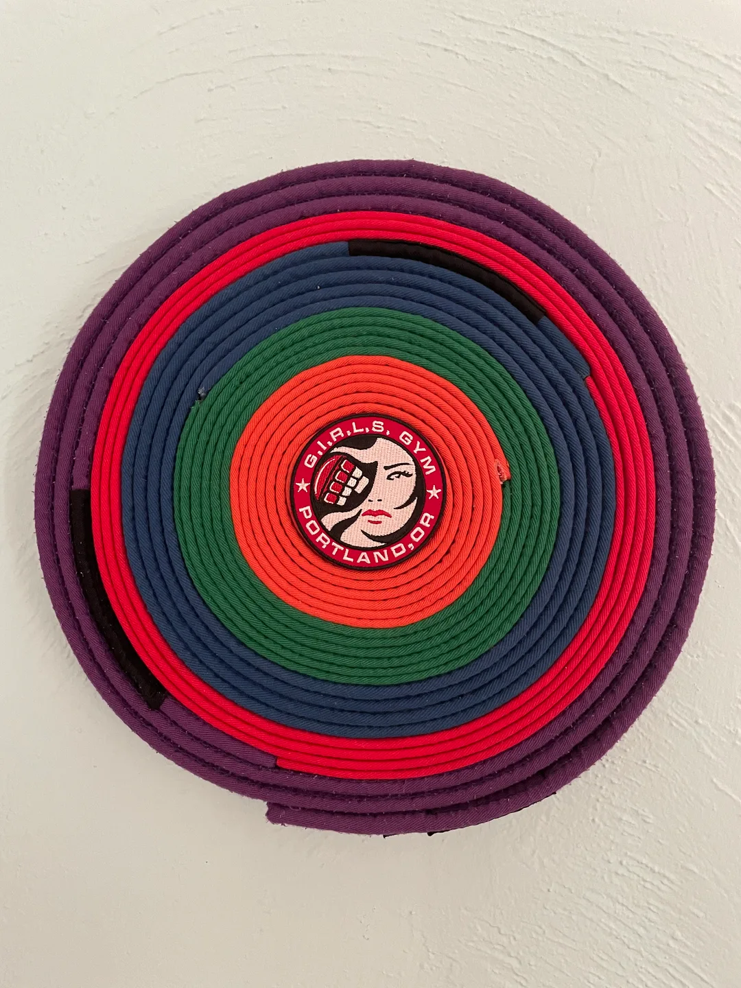 Brazilian jiu-jitsu belts Mom earned, arranged and displayed as art
