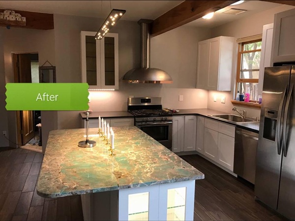 Kitchen remodel in Santa Fe, NM area featuring custom island with granite countertop, modern cabinetry, new exhaust hood, and updated ceiling lighting