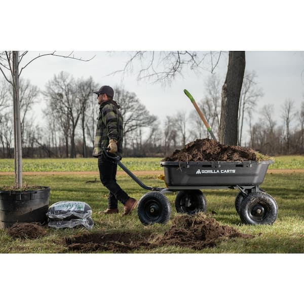 A person pulling their garden cart at work.