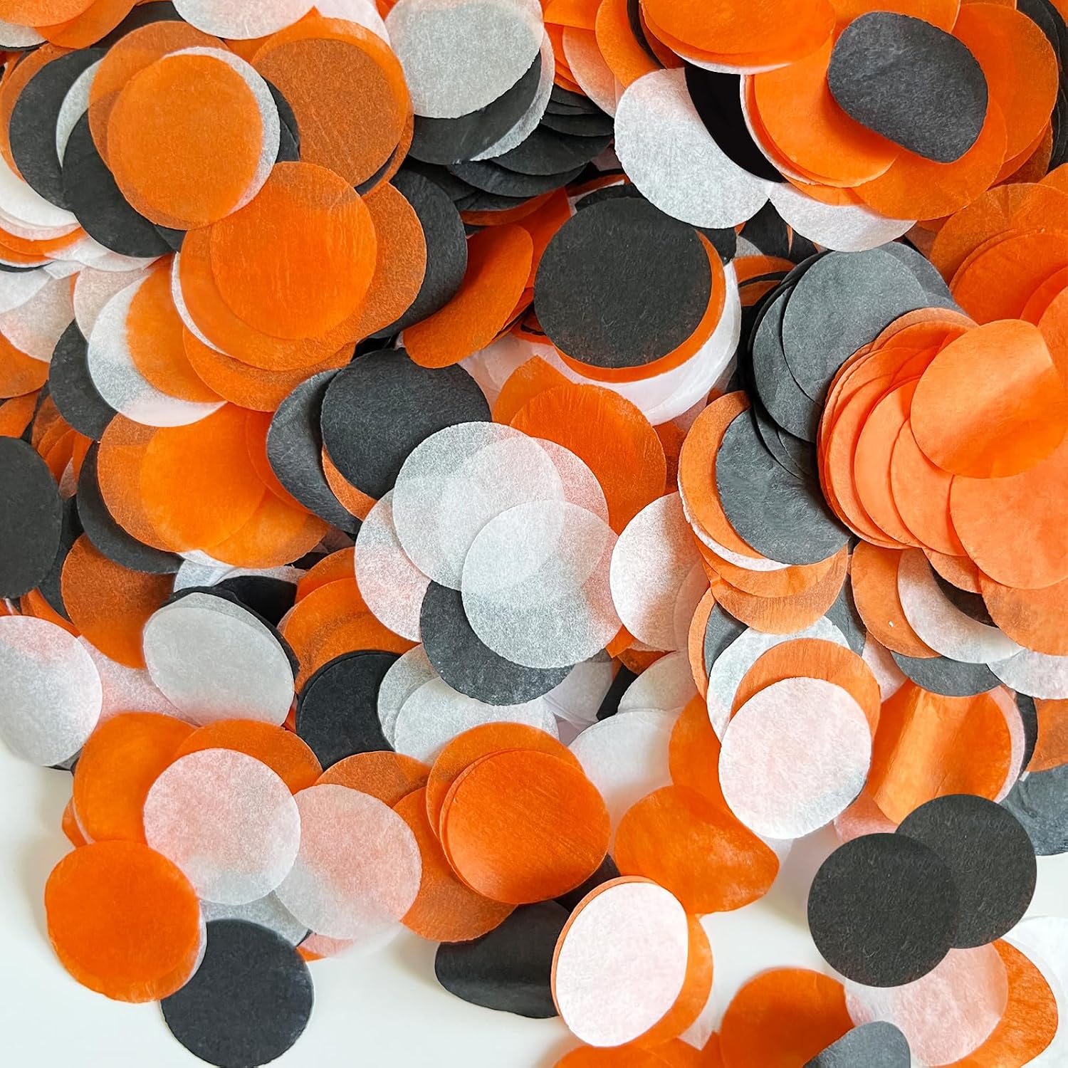 Orange, black, and white round tissue-paper confetti for Halloween decorating.