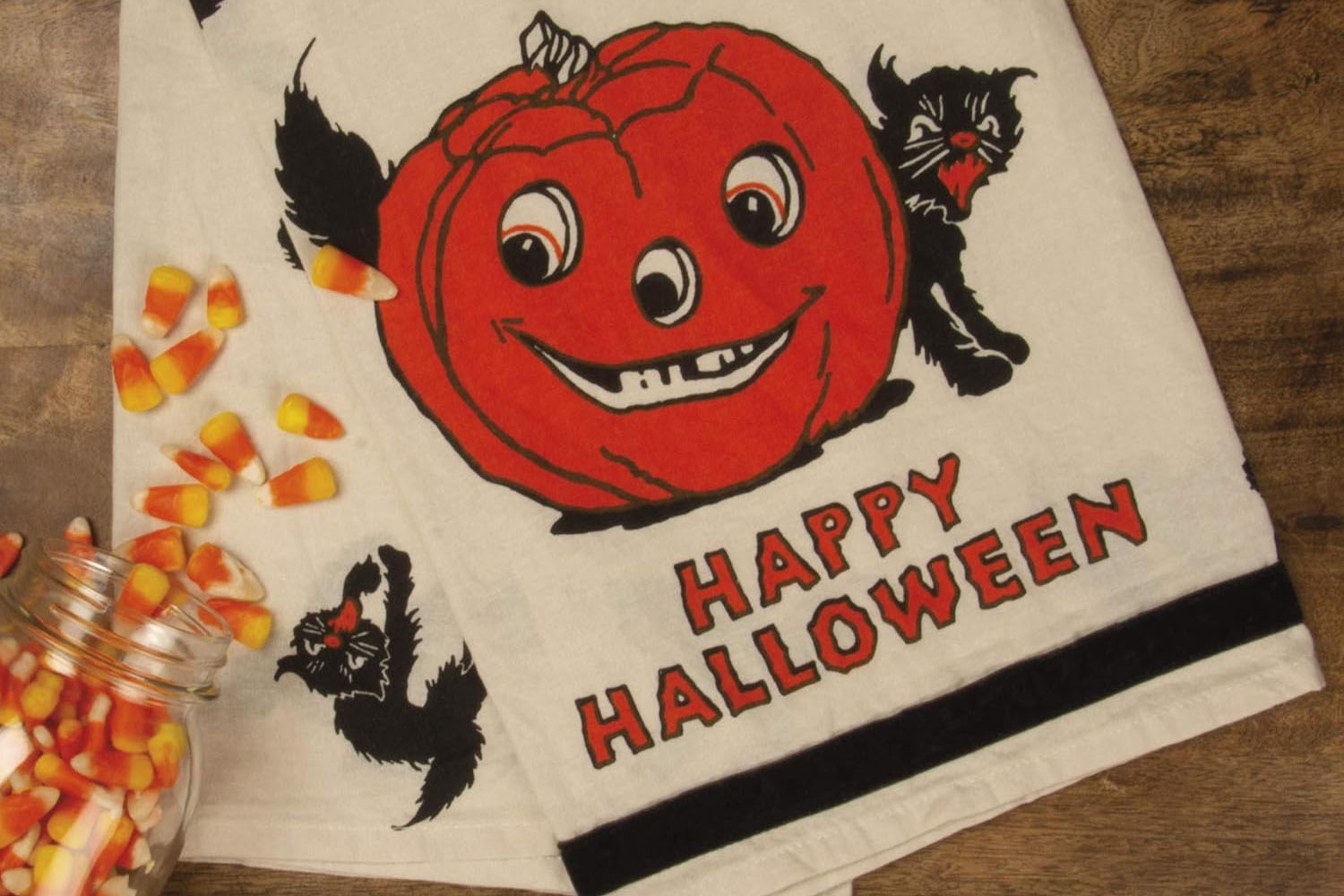 Retro Halloween dish towel featuring a jack-o’-lantern, black cats, and “Happy Halloween” lettering.