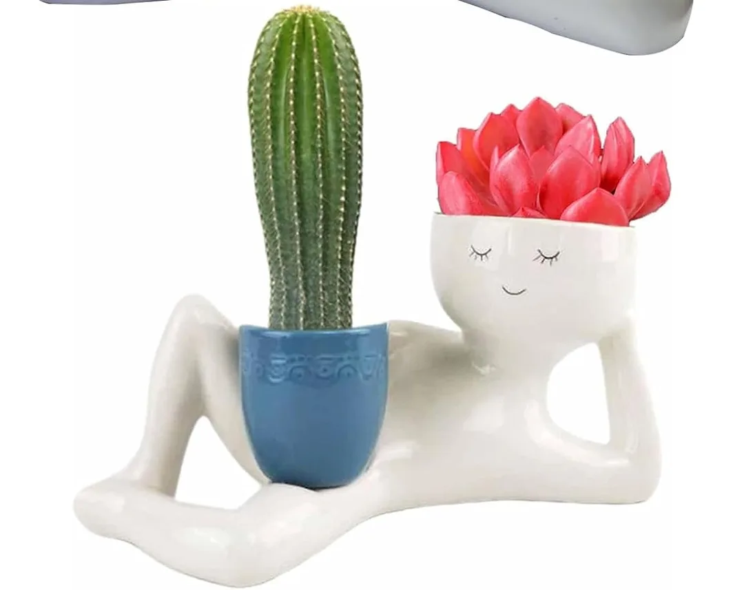 A person shaped planter that has a small pot in it's pelvic area.