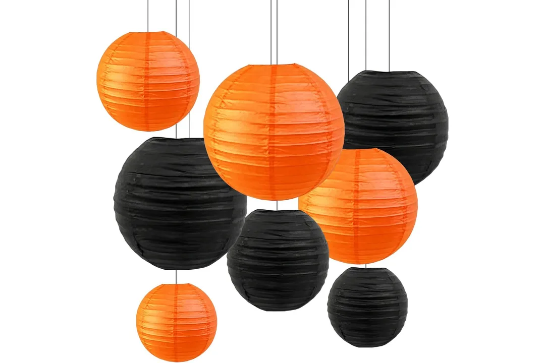 Orange and black paper lanterns in assorted sizes for Halloween decorating.