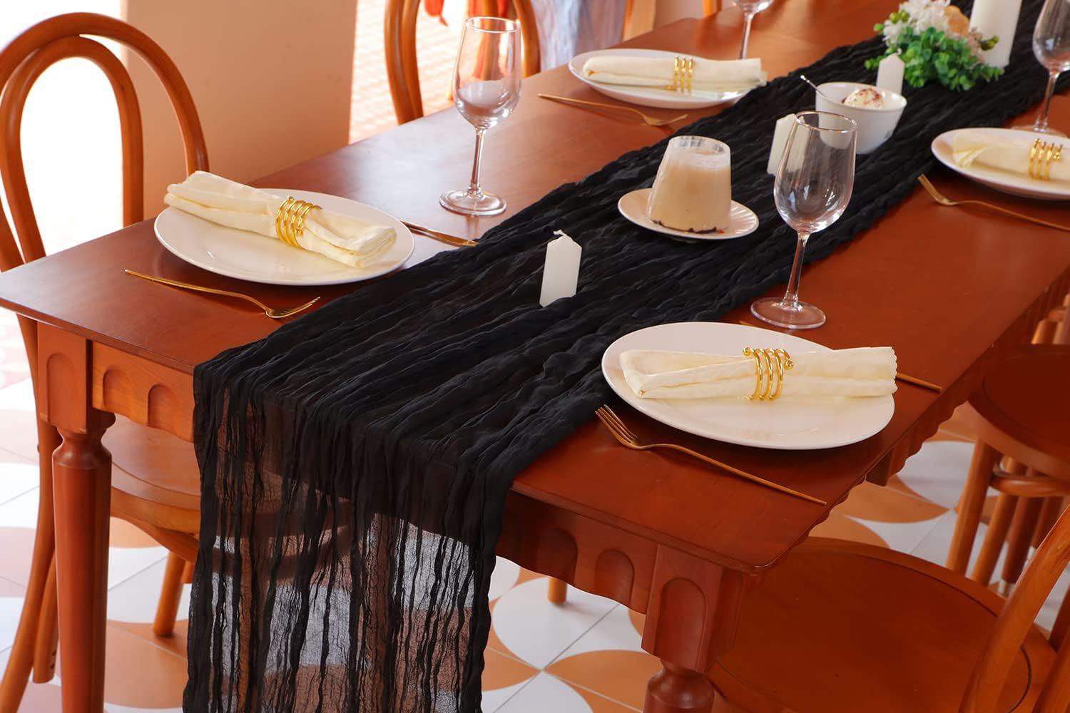 Long black sheer cheesecloth table runner with a soft, loosely woven gauze texture.