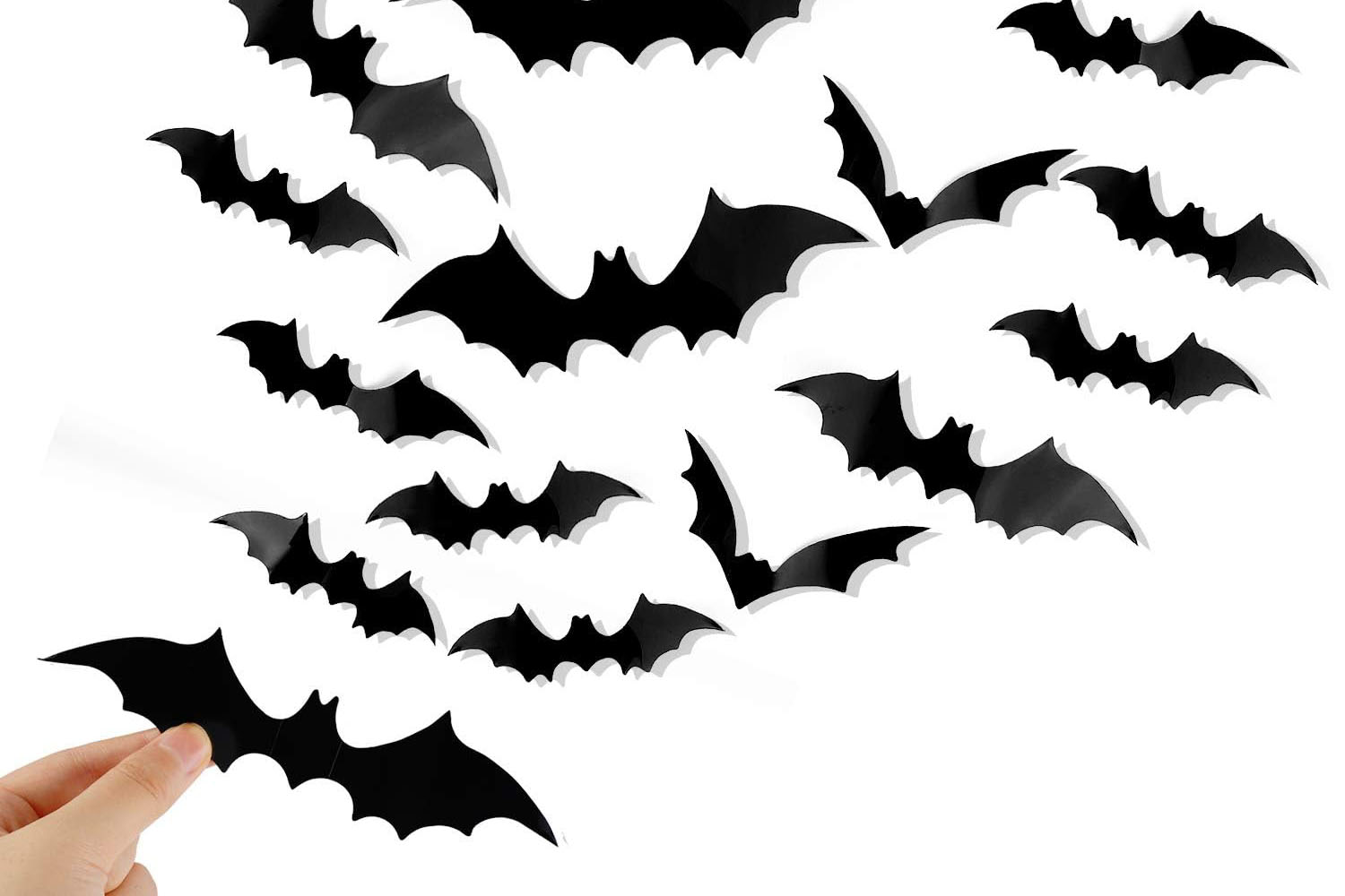 Assorted black 3D bat wall decorations in four sizes arranged as if flying across a wall.