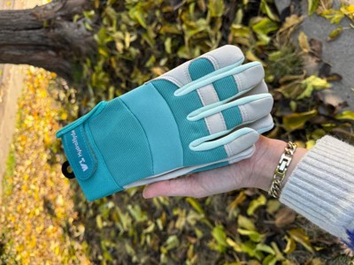 A person holding a pair of gloves.