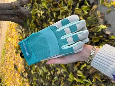 A person holding a pair of gloves.